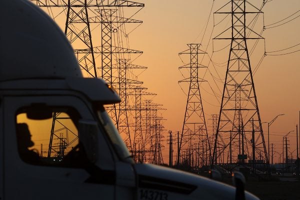 A truck passes a row of high voltage transmission towers on February 21, 2021 in Houston, Texas.