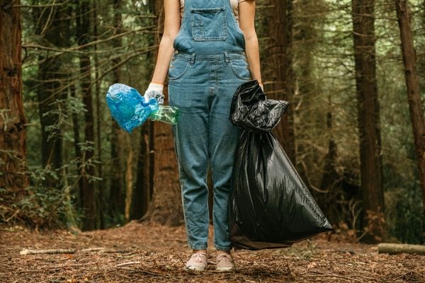 Volunteer collecting garbage from park