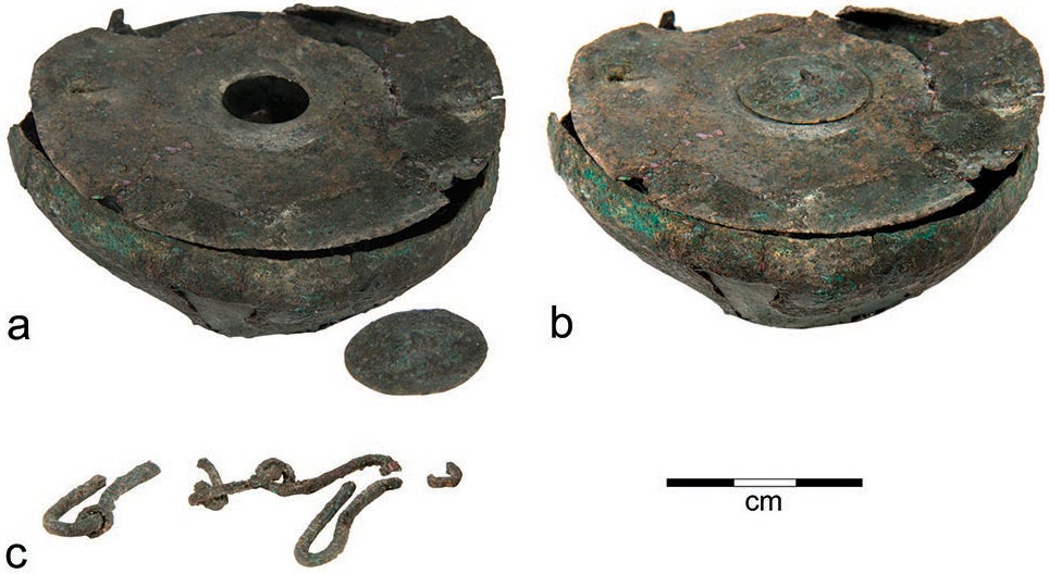 Parts of a bronze inkwell from Tel Kedesh: a, bowl with small cover removed; b, bowl with small cover in place; c, frag- ments of a chain that probably once stretched across the top of the lid 