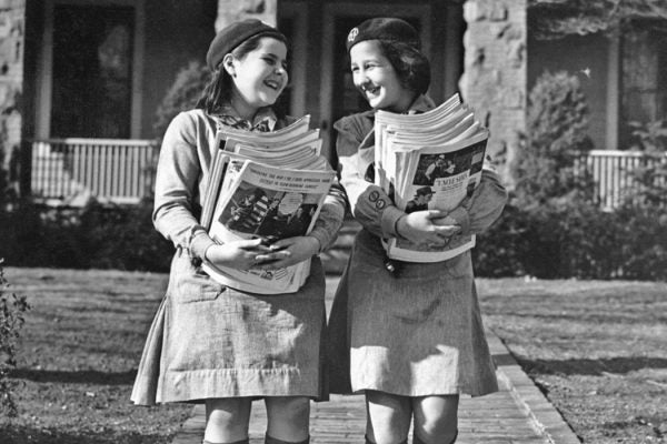 Two Girl Scouts collecting magazines