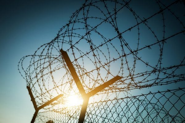 Photograph: Barbed Wire Fence in Jail.

Source: Getty