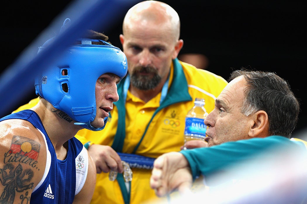 Damien Hooper of Australia listens to advice from his corner during the bout with Juan Carlos Carrillo of Colombia in the Boxing Men's Middle 75kg division on day 11 of the Singapore 2010 Youth Olympics at the International Convention Centre on August 25, 2010 in Singapore