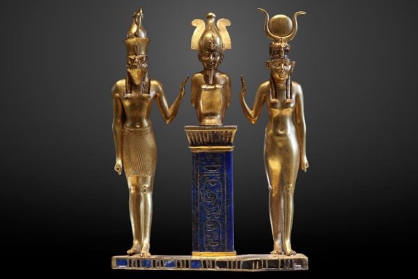 Osiris flanked by Horus on the left and Isis on the right