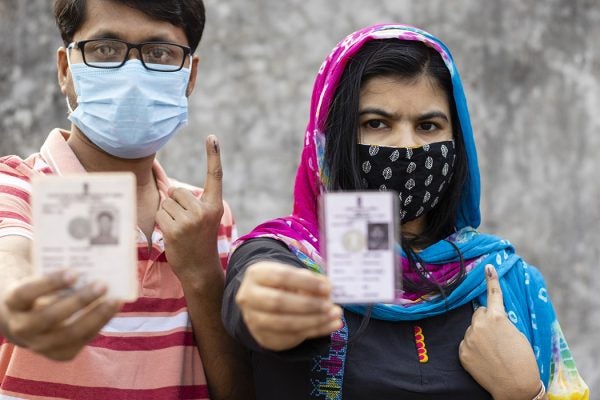A Man And Woman Showing Ink-Marked Finger And Voter Card in Calcutta, India