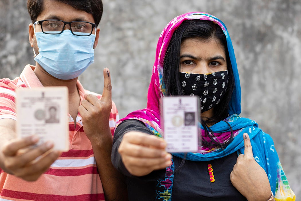 A Man And Woman Showing Ink-Marked Finger And Voter Card in Calcutta, India