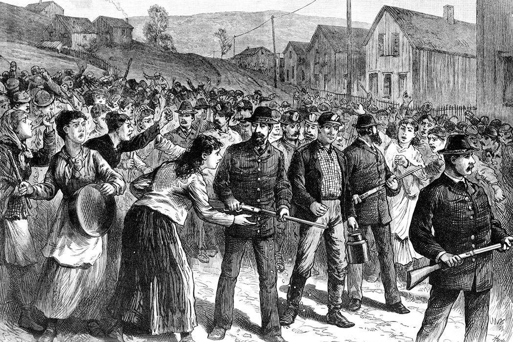 Striking miners in Buchtel, Ohio receiving "Blackleg" workmen when returning from their work escorted by a detachment of Pinkerton's detectives