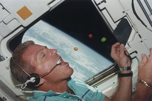 Astronaut Loren J. Shriver, Mission Commander of STS-46, attempts to eat floating sweets on the flight deck of the shuttle Atlantis during its orbit of the earth, August 1992.