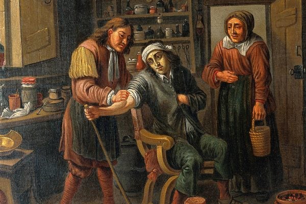 Physician letting blood from a man's arm