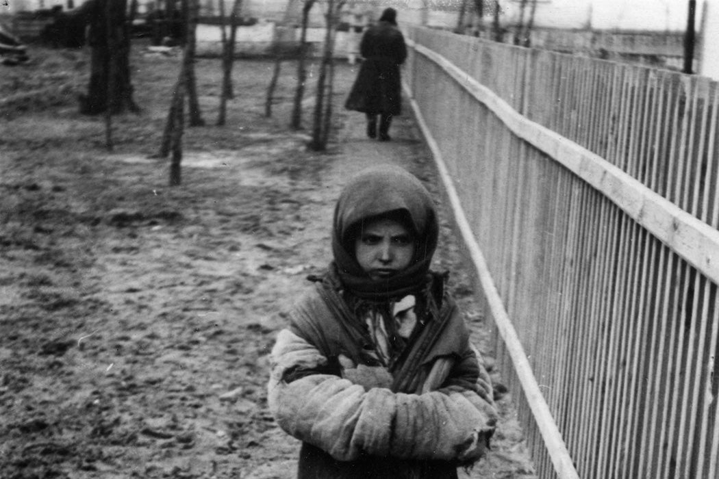 Photograph: A Russian orphan in Kiev during the famine. Her parents died from starvation and she survives on charity from a neighbour. 1934