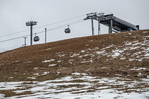 Empty cable cars hang over a ski slope that has had to be closed because of a lack of snow, on January 30, 2020 in Minamiuonuma, Japan.