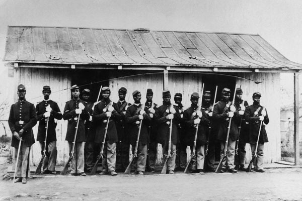A line of black civil war soldiers holding their rifles circa 1860
