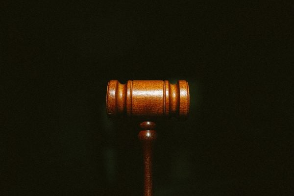 A gavel against a black background