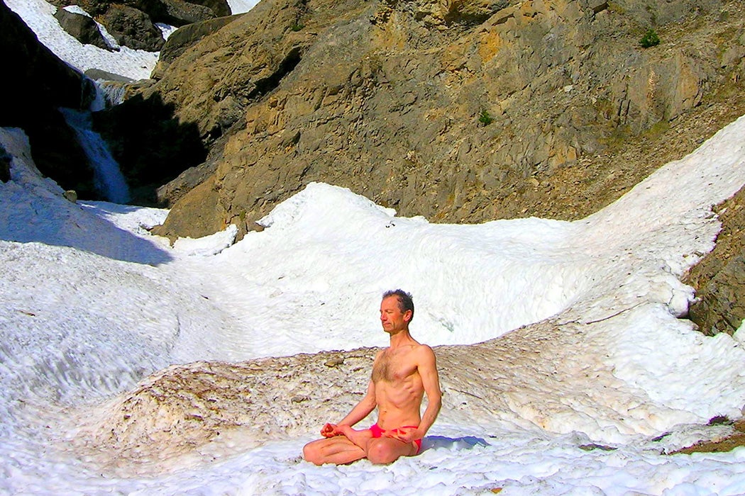 A person meditating in the snow