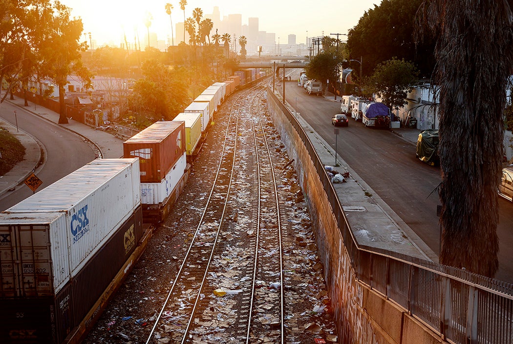 A Union Pacific freight train passes along a section of tracks littered with debris from packages stolen from cargo containers stacked on rail cars on January 19, 2022 in Los Angeles, California.