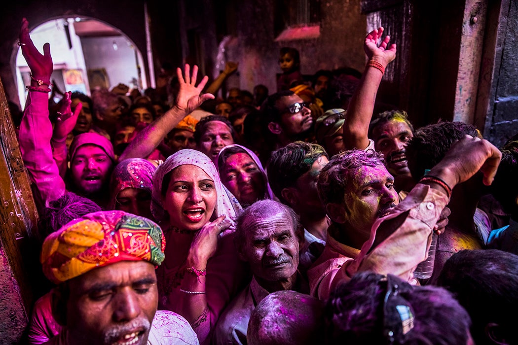 Hindu devotees celebrate during Holi with colored powders at the Banke Bihari temple on March 26, 2013 in Vrindavan, India.