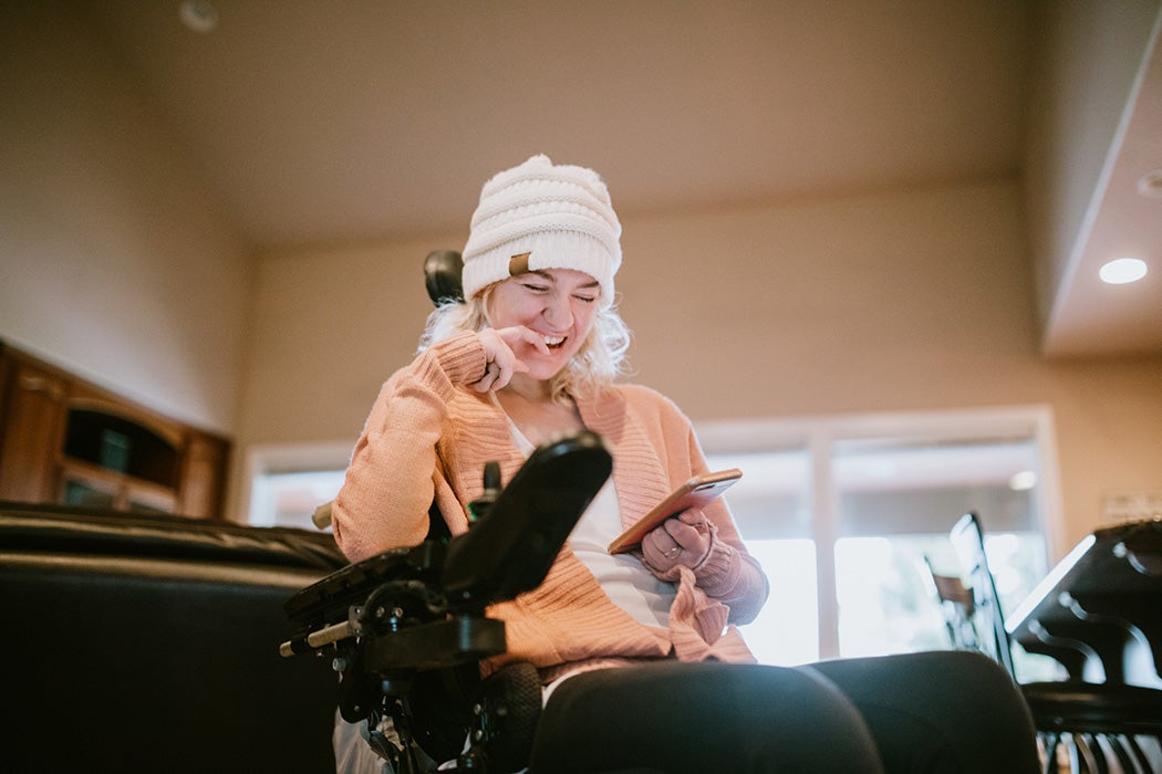 A woman with cerebral palsy using her phone