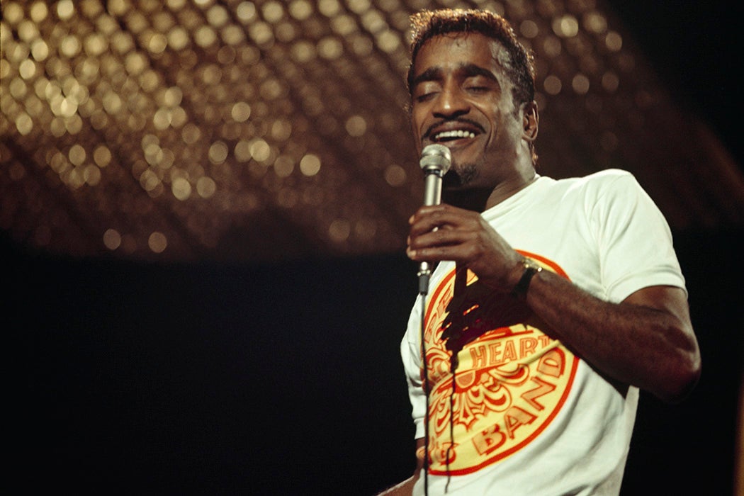 Sammy Davis Jr, wearing a Beatles t-shirt, performs on stage at The Talk of The Town in London, England in 1967
