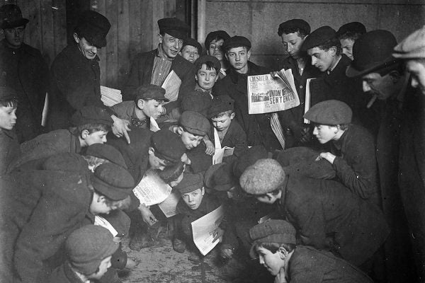 Newsboys amusing themselves while waiting for morning papers, New York, 1908