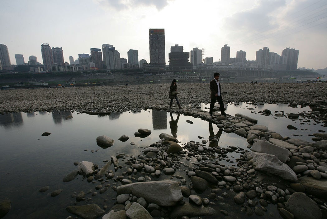 People walk on the Jialing River bed during a drought period on December 12, 2007 in Chongqing Municipality, China.