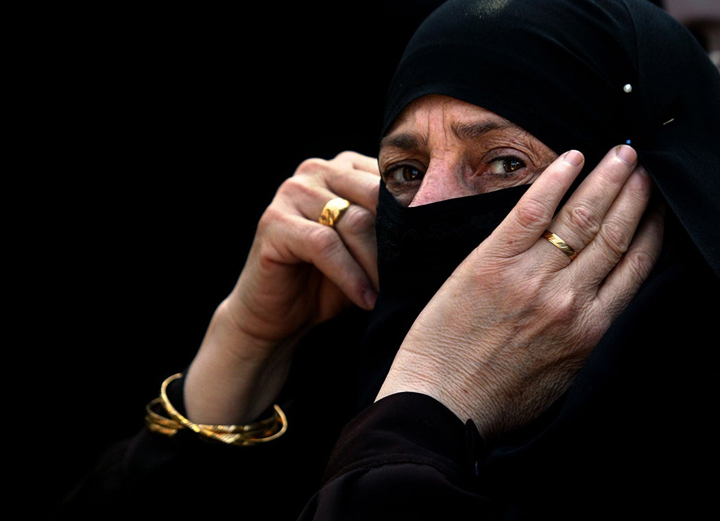 A Palestinian woman attends a protest against the French proposal to bar Muslim women from wearing headscarves in state schools at the French Culture Council on January 17, 2004 in Gaza City