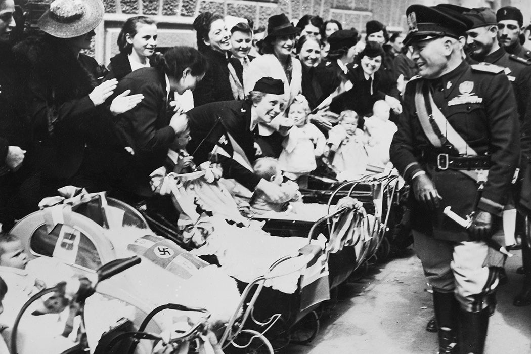 Benito Mussolini meets an enthusiastic group of mothers and their babies in Turin, circa 1940.