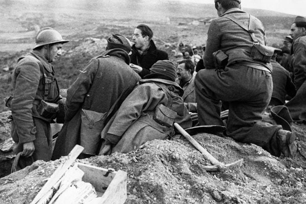 News reporters mingle with members of the International Brigade, amongst them is Ernest Hemingway (with mustache and glasses), during the Spanish Civil War, c. 1937.