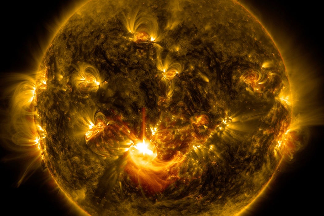 NASA's Solar Dynamics Observatory captured this image of a mid-level solar flare – as seen in the bright flash in the middle –on Dec. 16, 2014 shortly before midnight EST.