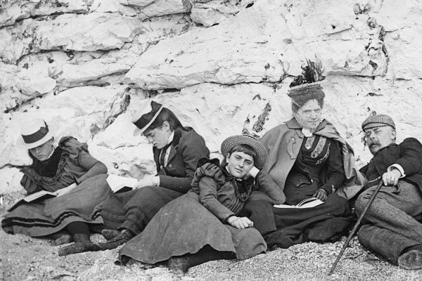 A group of holiday-makers sunning themselves on the beach at a South Coast resort, 1895