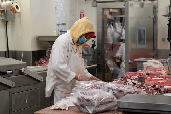 A butcher processes some meat at Vincents Meat Market on April 17, 2020, in Bronx, New York City