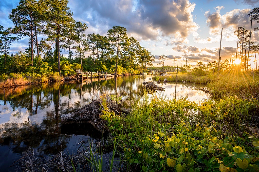 Early morning sunlight bathing an inlet on Florida's Emerald Coast