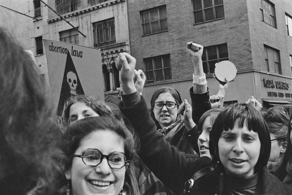 Protestors raise their fists as they take to the streets during a mass demonstration against New York State abortion laws, in the Manhattan borough of New York City, New York, 28th March 1970