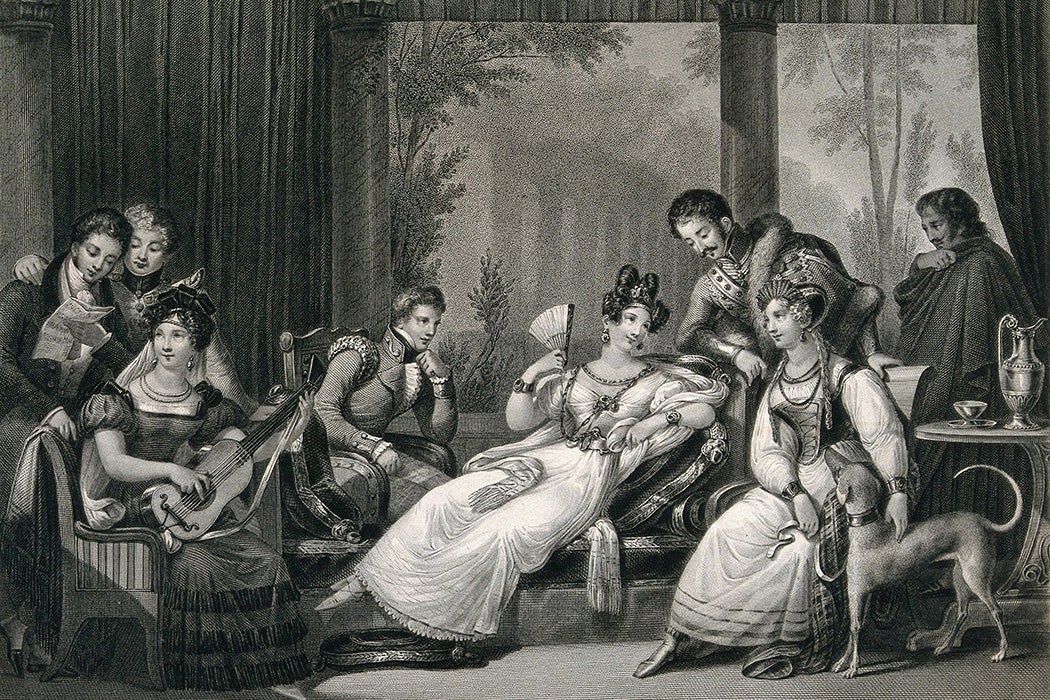 Three women and five men gathered in a room which opens up to classical architecture, the group on the left is making music while the others are engaged in conversation; representing the continent of Europe.