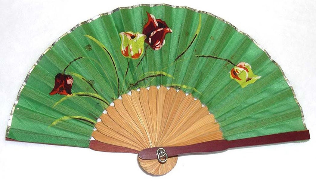 Small fan with wooden sticks and guards. Green fabric leaf painted with red, yellow, and green flowers.