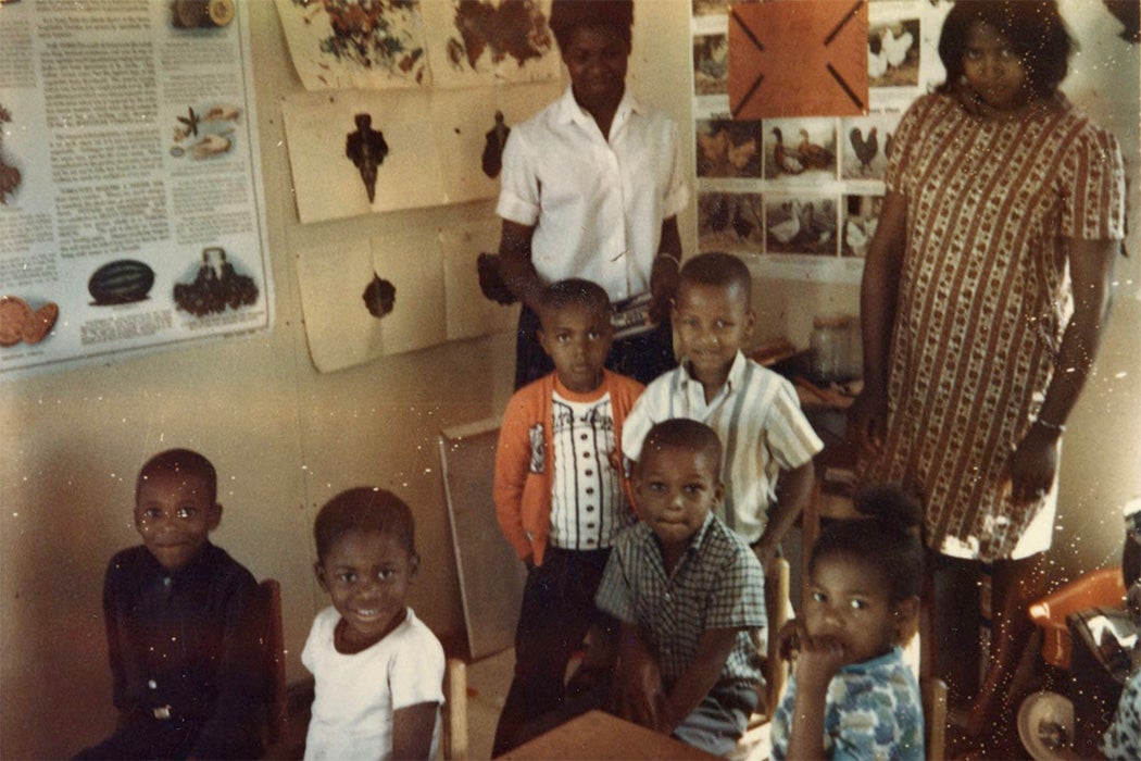 Black teachers and children stand facing the camera in a classroom in Mississippi, 1967