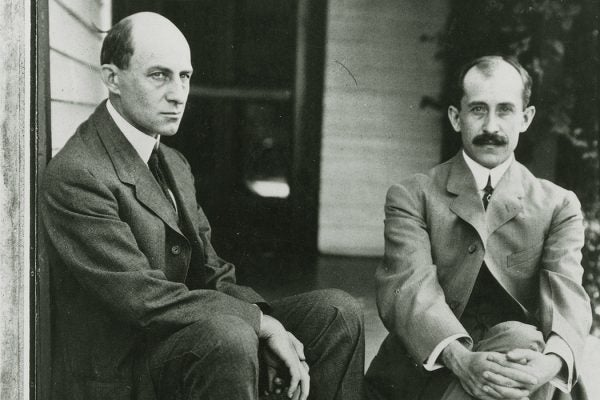 Wilbur, left, and Orville Wright sit on the porch steps of their Dayton, Ohio, home in June 1909.