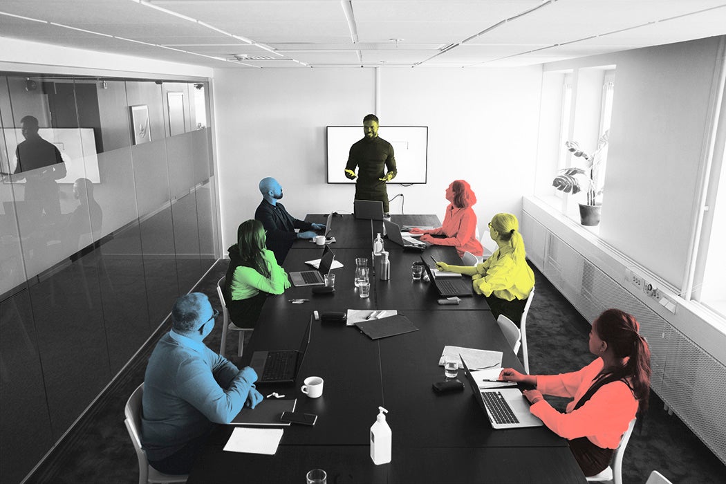 High angle view of businessman giving presentation colleagues in board room at office