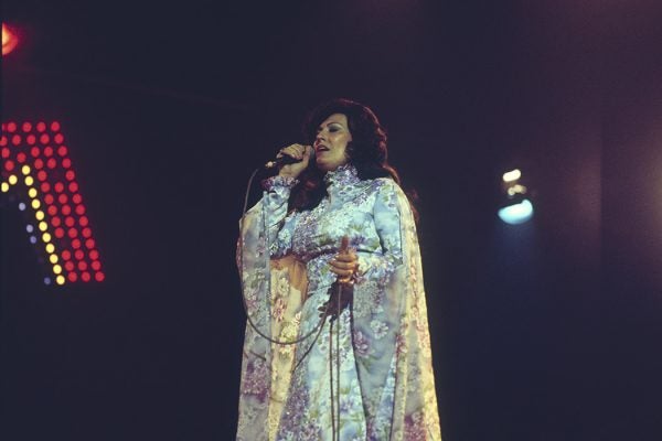 Loretta Lynn performs on stage at the Country Music Festival held at Wembley Arena, London in April 1977.