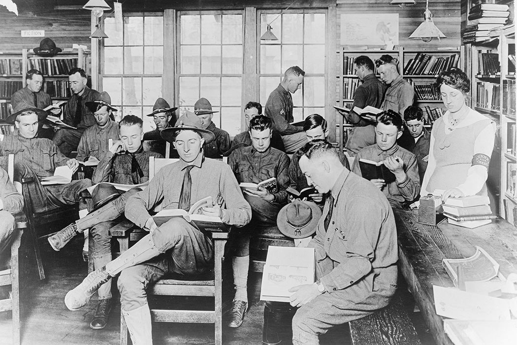 U.S. soldiers reading books in a YMCA library