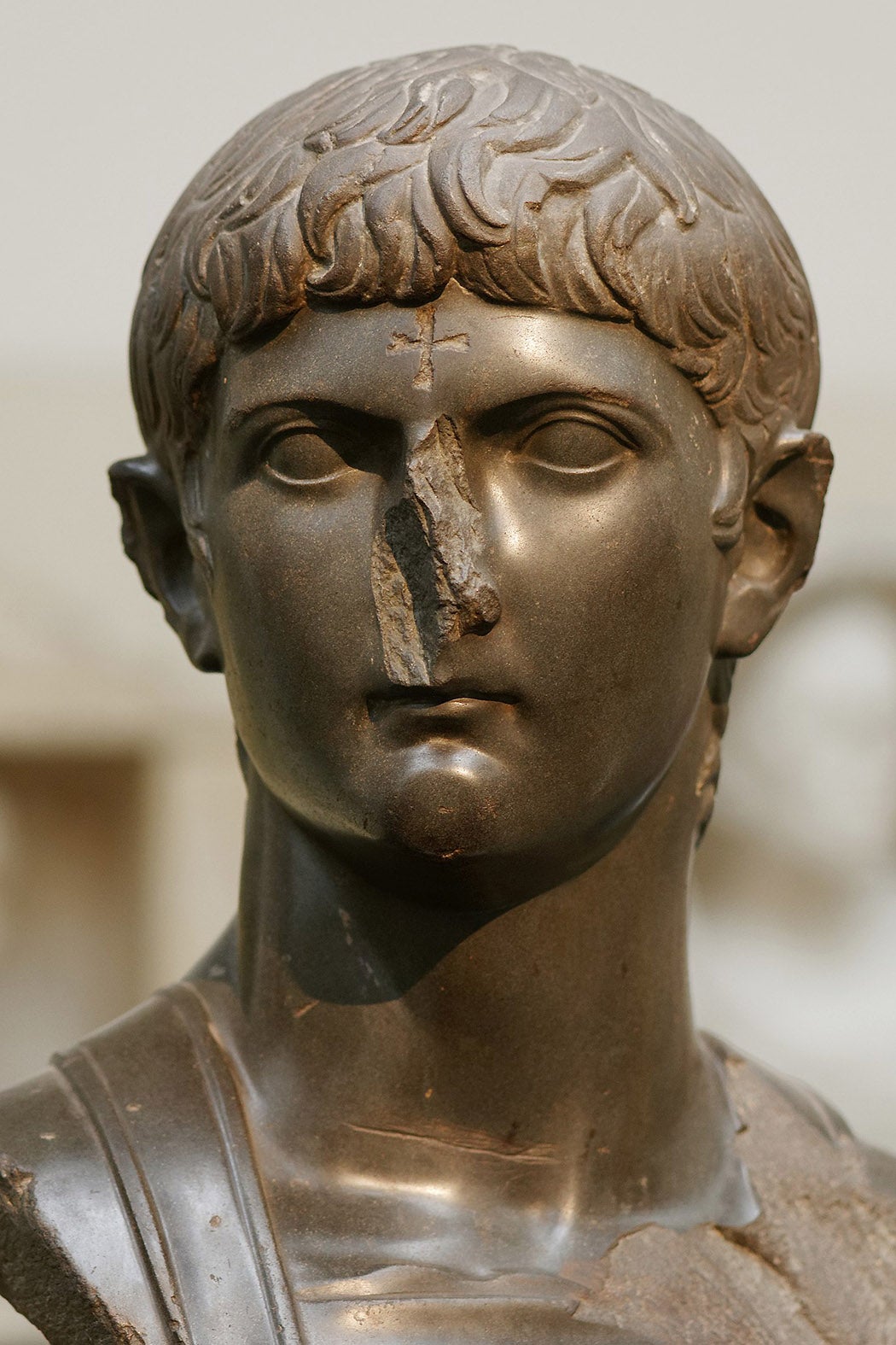 Bust of Germanicus in military dress. The nose has been broken and a cross carved on the forehead by Christians in late antiquity.