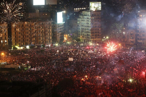 Fireworks and shouts of joy emanate from Tahrir Square after a broadcast by the head of the Egyptian military confirming that they will temporarily be taking over from the country's first democratically elected president Mohammed Morsi on July 3, 2013 in Cairo, Egypt.