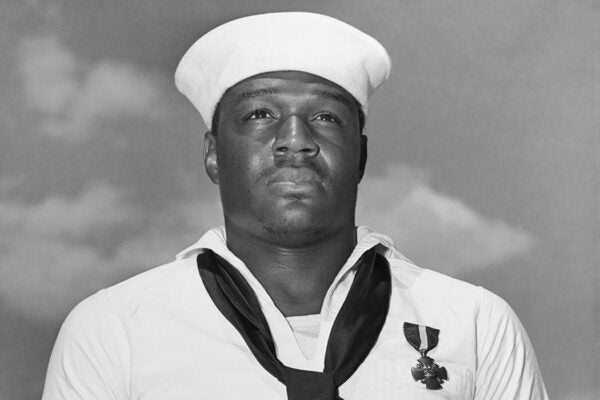 Doris Miller just after being presented with the Navy Cross by Admiral Chester W. Nimitz, on board USS Enterprise at Pearl Harbor, May 27, 1942.