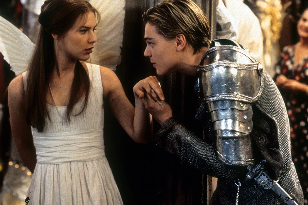 Claire Danes is surprised as Leonardo DiCaprio takes her hand to kiss in scene from the film Romeo + Juliet, 1996. Getty