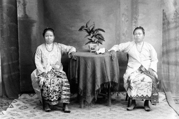 Two Peranakan women at a tin factory in Pulau Singkep, Riau Islands.