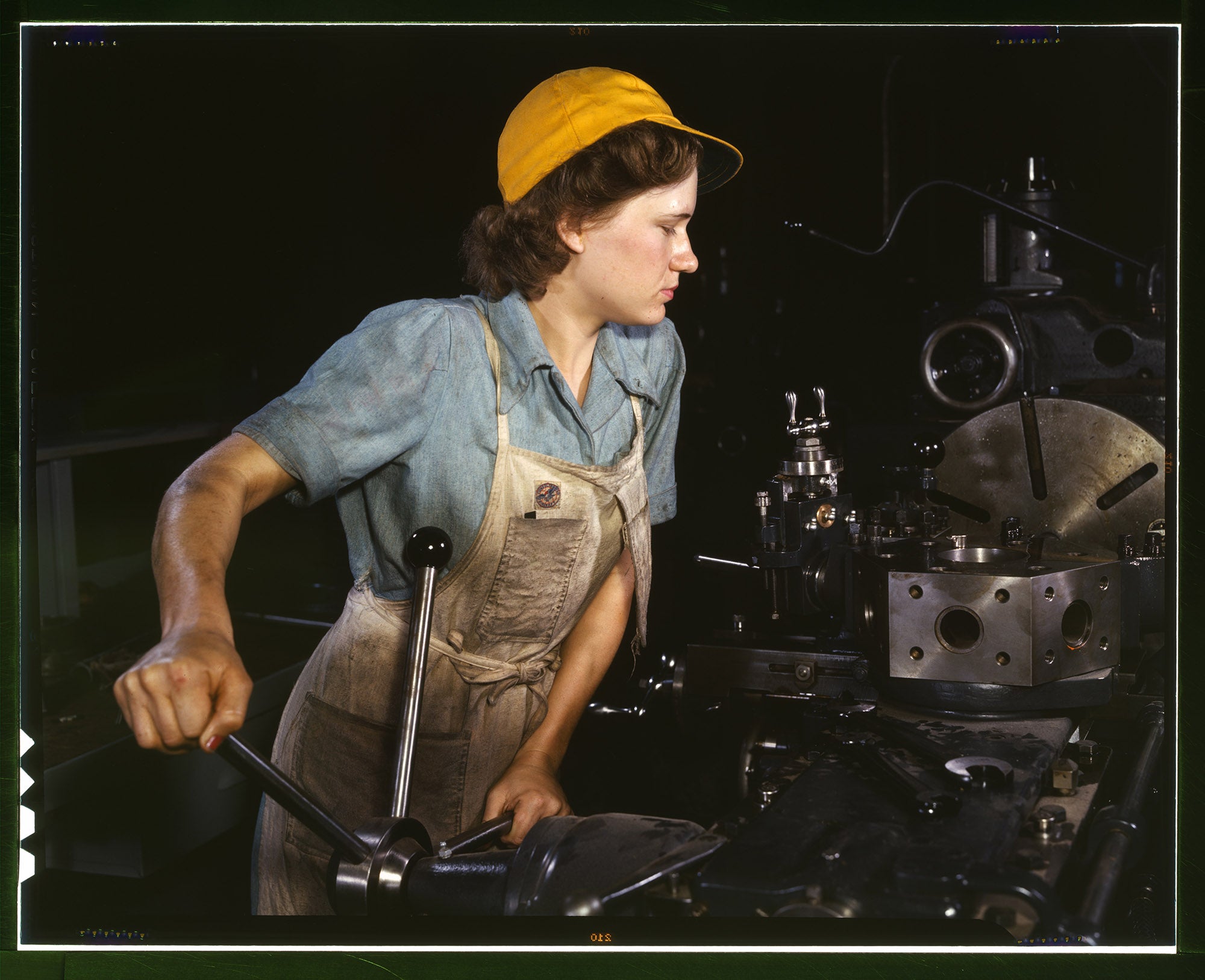 Lathe operator machining parts for transport planes at the Consolidated Aircraft Corporation plant, Fort Worth, Texas, 1942