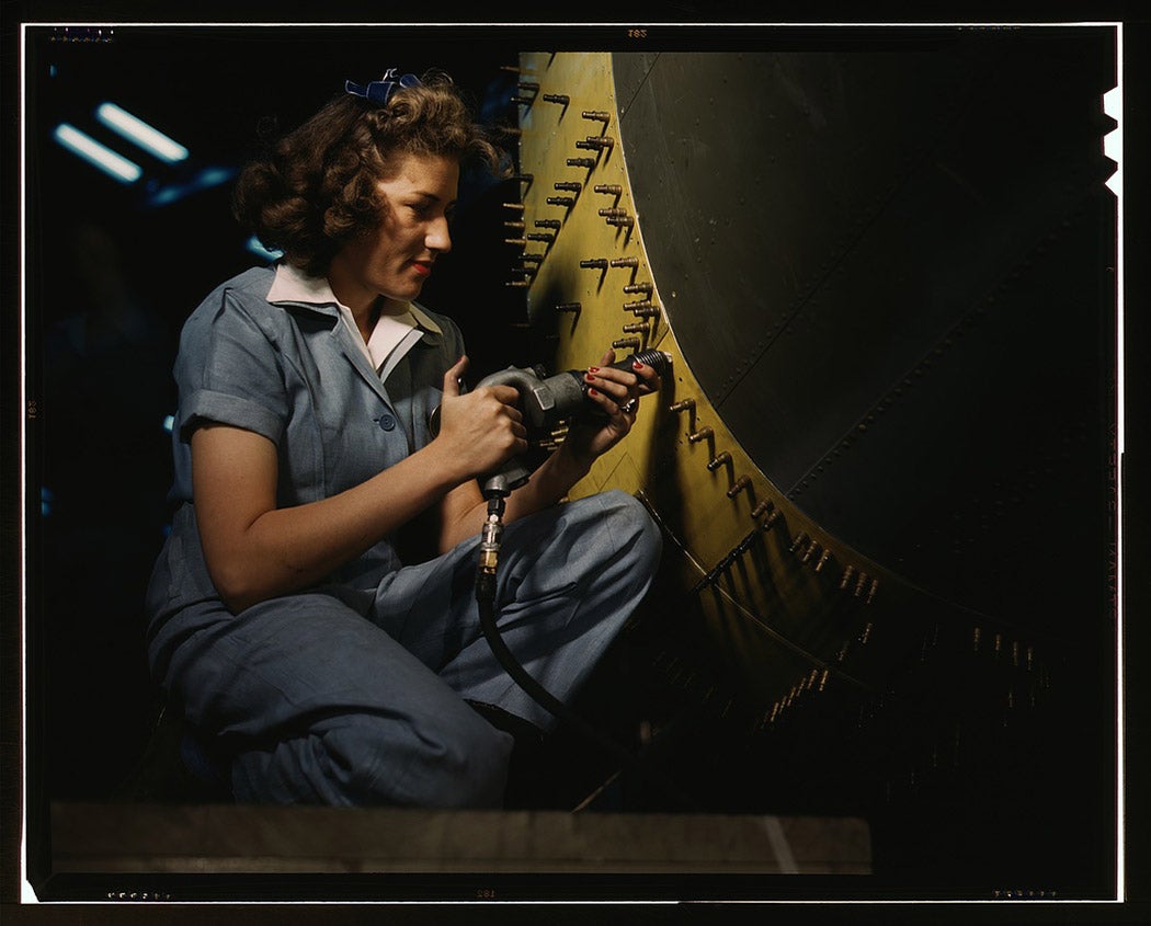 Riveter at work on Consolidated bomber, Consolidated Aircraft Corp., Fort Worth, Texas, 1942