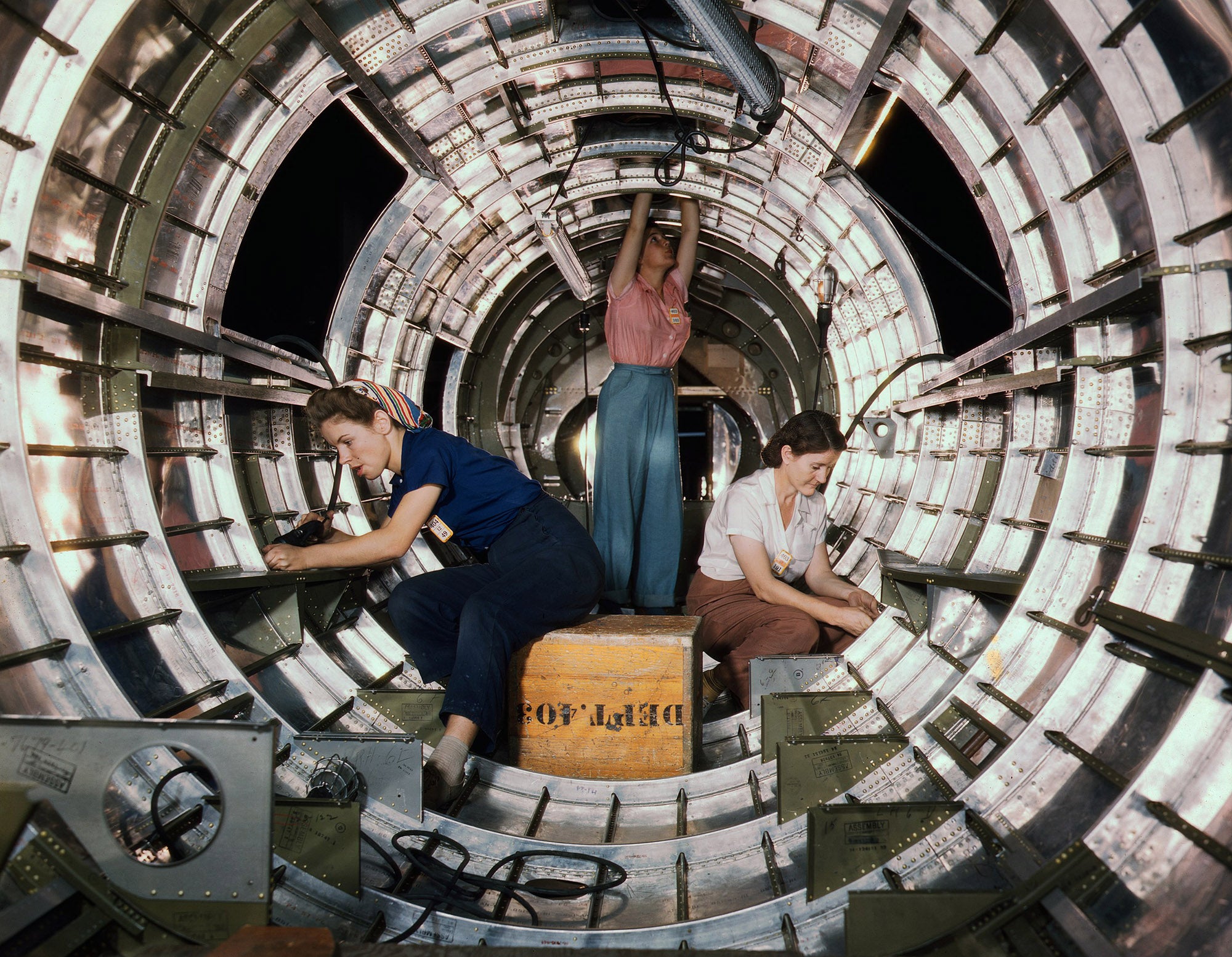 Women workers install fixtures and assemblies to a tail fuselage section of a B-17 bomber at the Douglas Aircraft Company plant, Long Beach, California, 1942