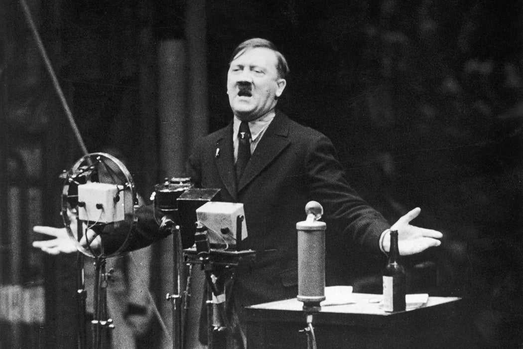 1935: Nazi leader Adolf Hitler speaks in front of microphones and gestures with his hands. Original Publication: From the newsreel 'The March of Time'. (Photo by Hulton Archive/Getty Images)