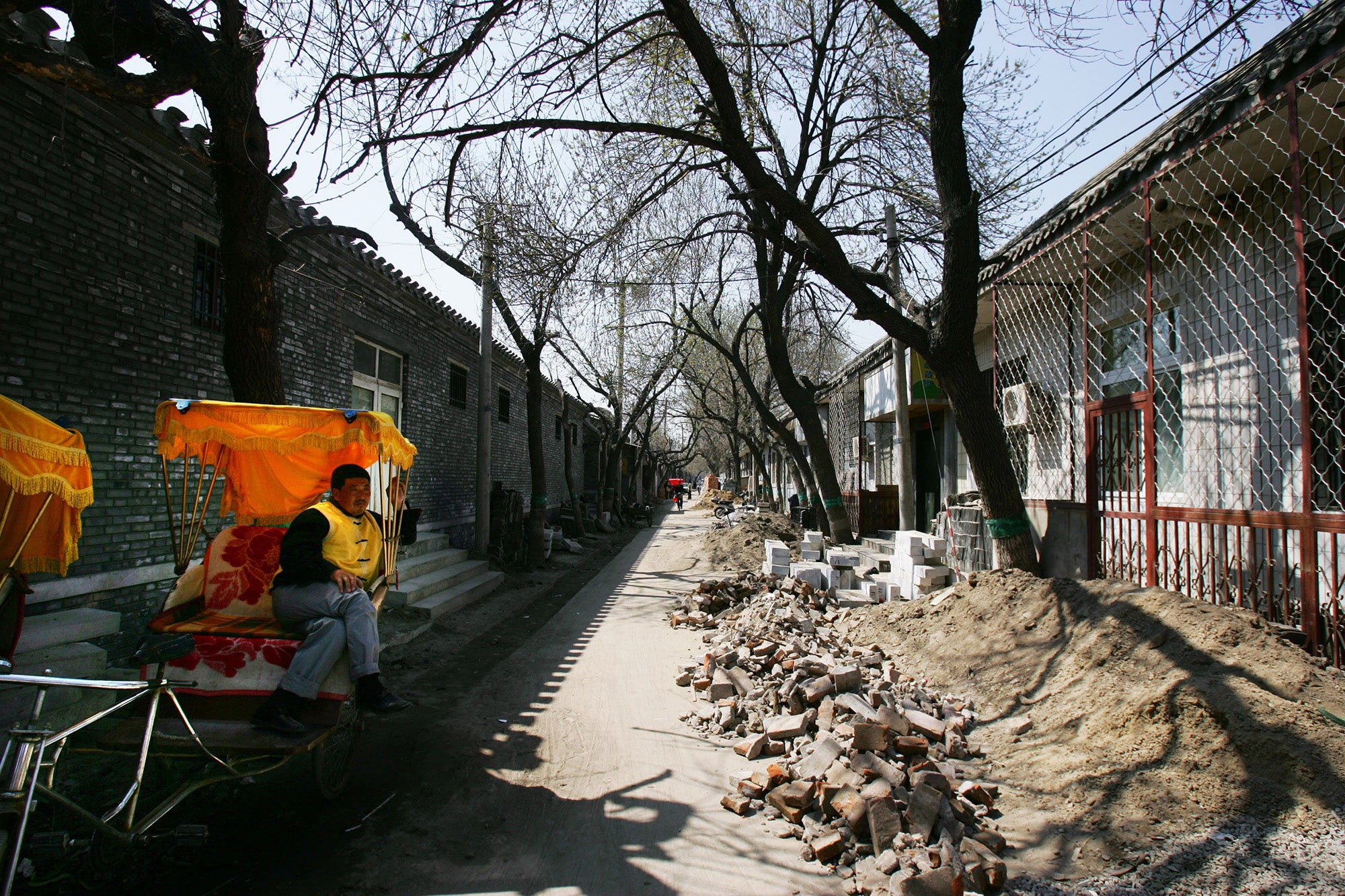 A rickshaw puller rests in a Hutong at Houhai Lake area on April 4, 2008 in Beijing, China.