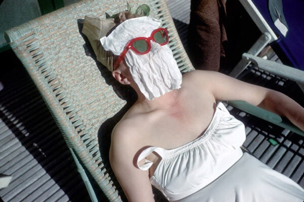 A woman sunbather covers her face as she tans, June 1949 at Sea Island Resort, Georgia