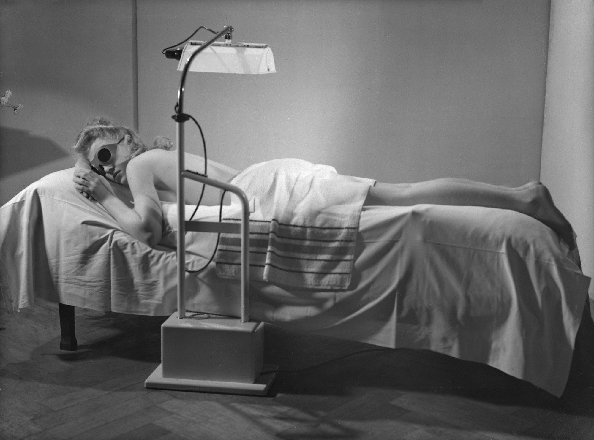 A woman beneath a Philips Sunlamp, 1956